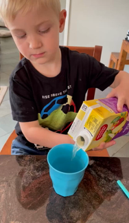 Pouring himself a juice